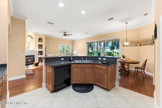 85339 Amagansett Dr, Fernandina Beach, FL 32034 - kitchen featuring dishwasher, crown molding, light wood-style floors, open floor plan, and a glass covered fireplace