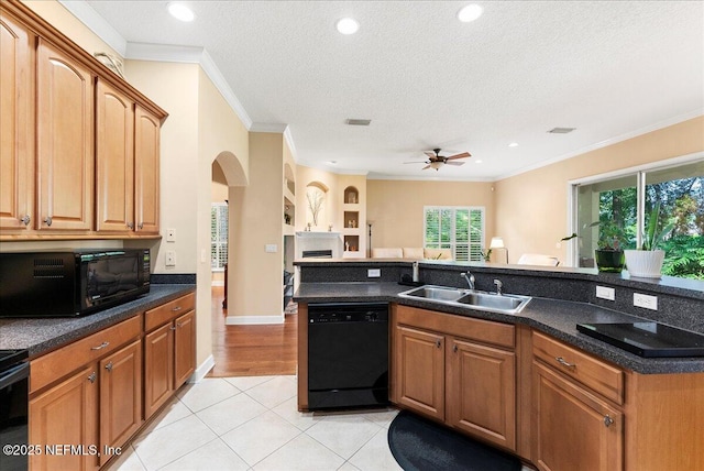 85339 Amagansett Dr, Fernandina Beach, FL 32034 - kitchen with black appliances, ceiling fan, arched walkways, ornamental molding, and a textured ceiling