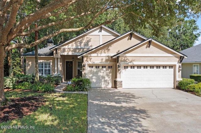 85339 Amagansett Dr, Fernandina Beach, FL 32034 - view of front facade featuring an attached garage, driveway, stucco siding, and stone siding