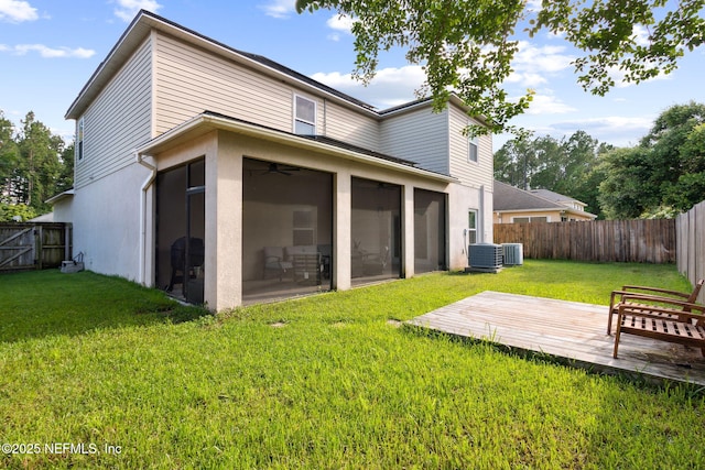 86051 Venetian Ave, Yulee, FL 32097 - back of house featuring a wooden deck, a sunroom, a fenced backyard, and stucco siding