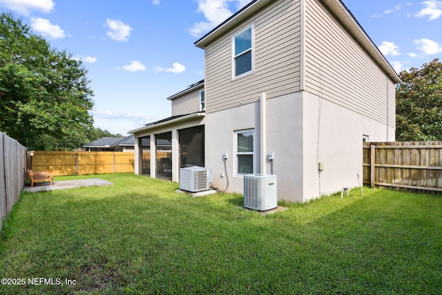 86051 Venetian Ave, Yulee, FL 32097 - rear view of house featuring a fenced backyard, a sunroom, stucco siding, and a patio