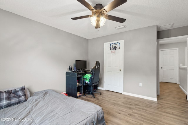 86051 Venetian Ave, Yulee, FL 32097 - bedroom featuring wood finished floors, a textured ceiling, attic access, and a ceiling fan