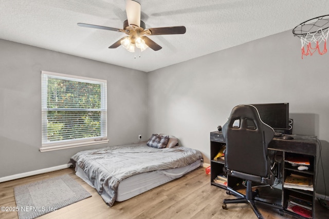 86051 Venetian Ave, Yulee, FL 32097 - bedroom featuring wood finished floors, an office area, a textured ceiling, and ceiling fan