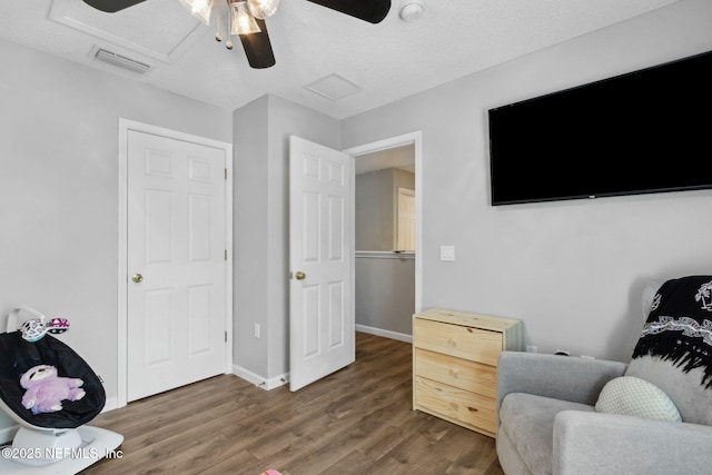 86051 Venetian Ave, Yulee, FL 32097 - sitting room with wood finished floors, ceiling fan, and attic access