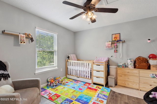 86051 Venetian Ave, Yulee, FL 32097 - bedroom featuring wood finished floors, ceiling fan, and a textured ceiling