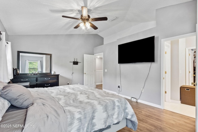 86051 Venetian Ave, Yulee, FL 32097 - bedroom with vaulted ceiling, wood finished floors, and a ceiling fan
