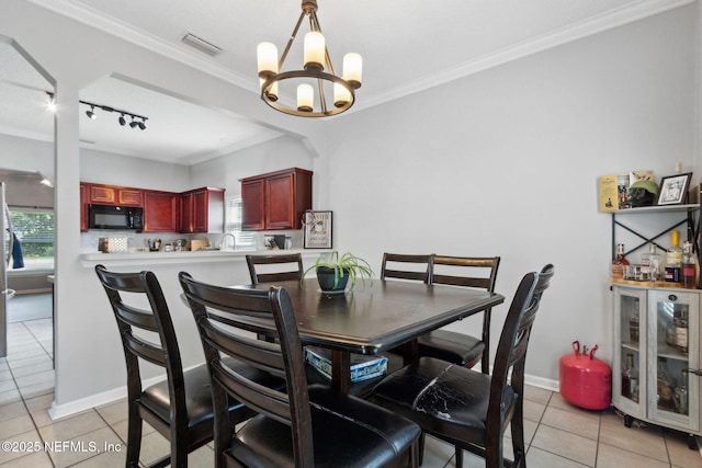 86051 Venetian Ave, Yulee, FL 32097 - dining room with light tile patterned floors, a chandelier, ornamental molding, and track lighting