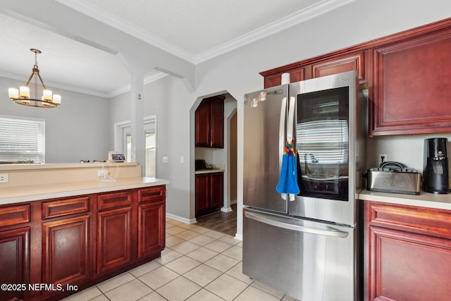 86051 Venetian Ave, Yulee, FL 32097 - kitchen with smart refrigerator, dark brown cabinets, light countertops, light tile patterned floors, and ornamental molding
