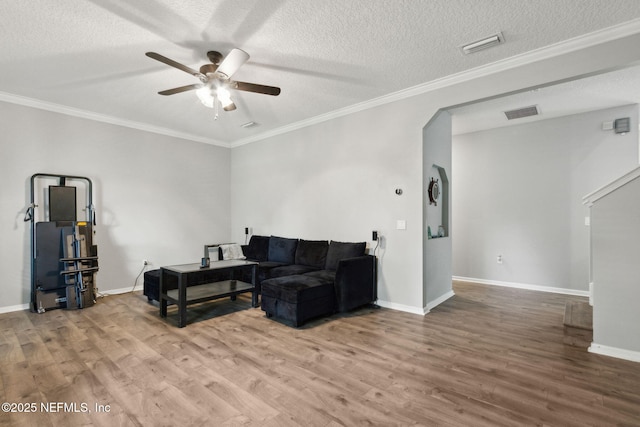86051 Venetian Ave, Yulee, FL 32097 - living room featuring ceiling fan, wood finished floors, crown molding, and a textured ceiling