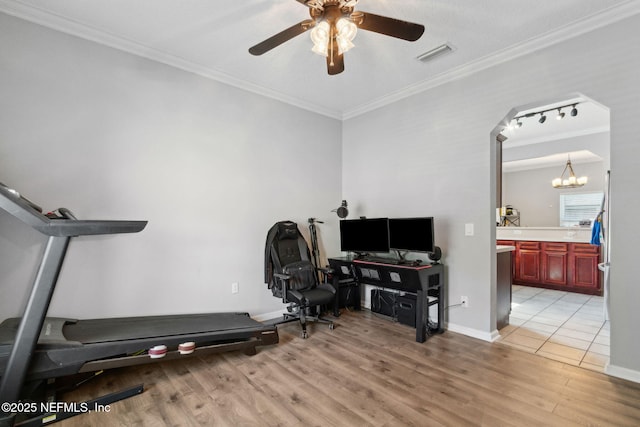 86051 Venetian Ave, Yulee, FL 32097 - exercise area with ornamental molding, light wood-style floors, a ceiling fan, a chandelier, and arched walkways