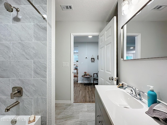 540485 US Highway 1, Callahan, FL 32011 - bathroom with vanity, shower / tub combination, marble finish floors, and a textured ceiling
