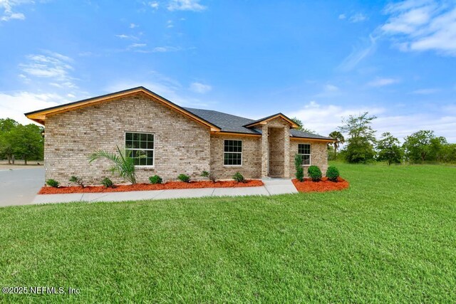 451632 Old Dixie Hwy, Callahan, FL 32011 - ranch-style house featuring brick siding and a front lawn