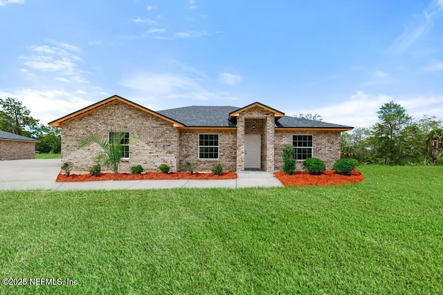 451632 Old Dixie Hwy, Callahan, FL 32011 - view of front facade with a front lawn, brick siding, and roof with shingles