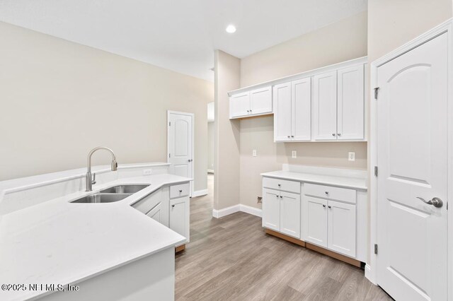 451632 Old Dixie Hwy, Callahan, FL 32011 - kitchen with white cabinetry, light countertops, light wood-style floors, and recessed lighting