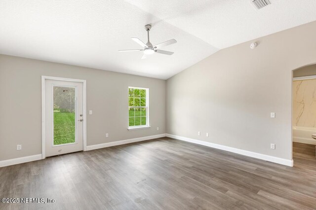 451632 Old Dixie Hwy, Callahan, FL 32011 - spare room with a ceiling fan, wood finished floors, vaulted ceiling, arched walkways, and a smoke detector