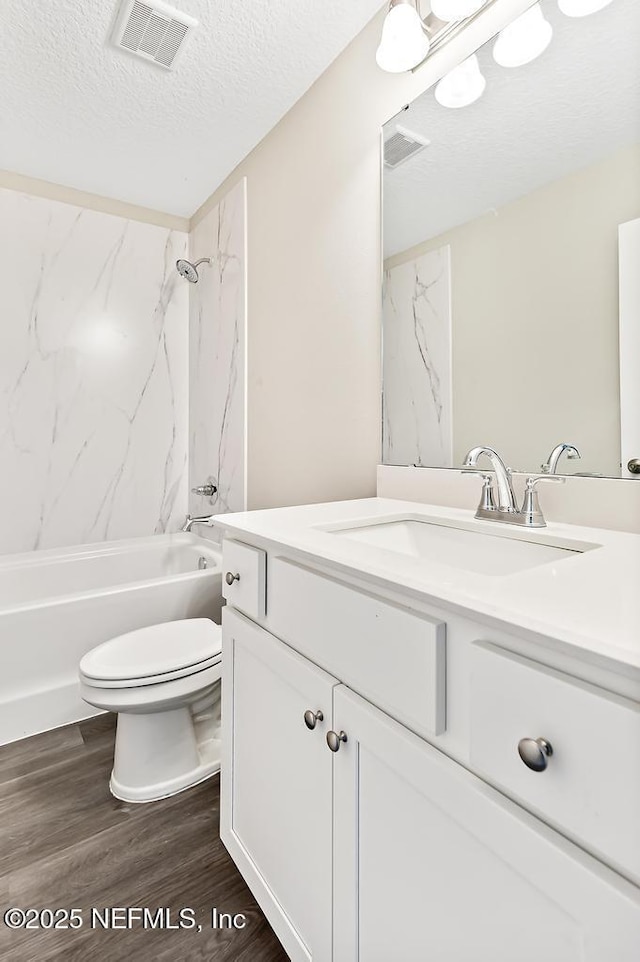 451632 Old Dixie Hwy, Callahan, FL 32011 - bathroom with vanity, a textured ceiling, wood finished floors, and washtub / shower combination