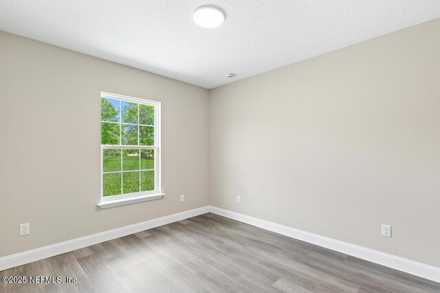451632 Old Dixie Hwy, Callahan, FL 32011 - unfurnished room featuring wood finished floors and a textured ceiling