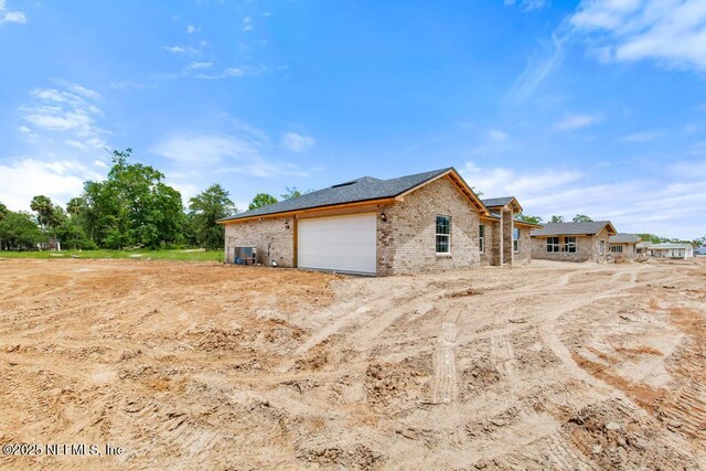 451632 Old Dixie Hwy, Callahan, FL 32011 - view of home's exterior featuring brick siding and a garage