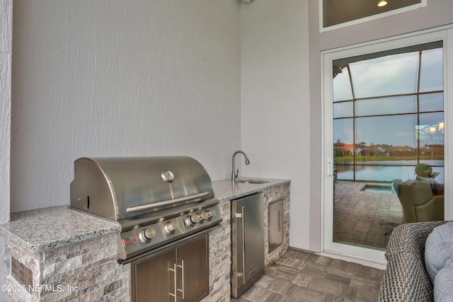 2459 Karatas Ct, Jacksonville, FL 32246 - view of patio with an outdoor kitchen and a water view