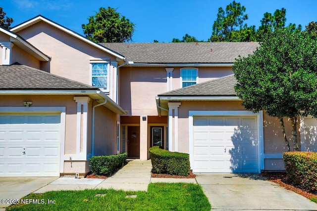 307 Southern Branch Ln, Saint Johns, FL 32259 - traditional-style house featuring an attached garage, stucco siding, concrete driveway, and a shingled roof