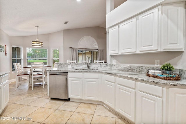 1630 Highland View Ct, Fleming Island, FL 32003 - kitchen featuring stainless steel dishwasher, vaulted ceiling, light tile patterned floors, white cabinetry, and a peninsula