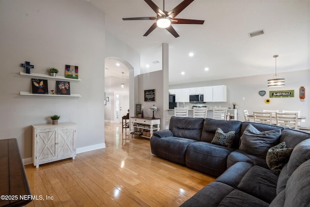 1630 Highland View Ct, Fleming Island, FL 32003 - living room featuring ceiling fan, arched walkways, high vaulted ceiling, light wood-style floors, and recessed lighting
