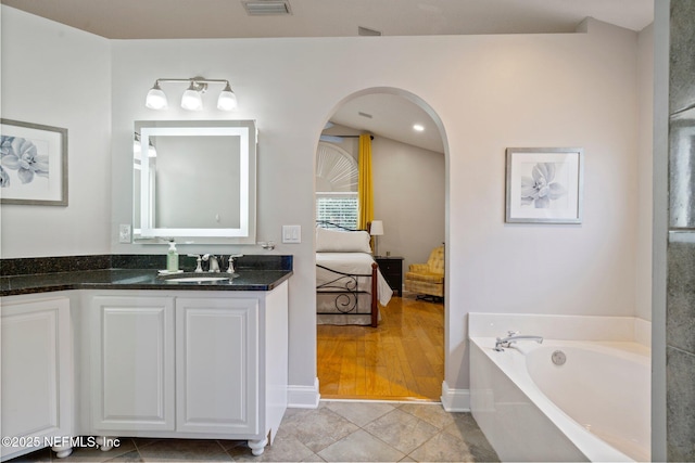 1630 Highland View Ct, Fleming Island, FL 32003 - ensuite bathroom with a garden tub and vanity