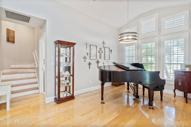 1630 Highland View Ct, Fleming Island, FL 32003 - living area featuring vaulted ceiling, light wood finished floors, a chandelier, and stairway