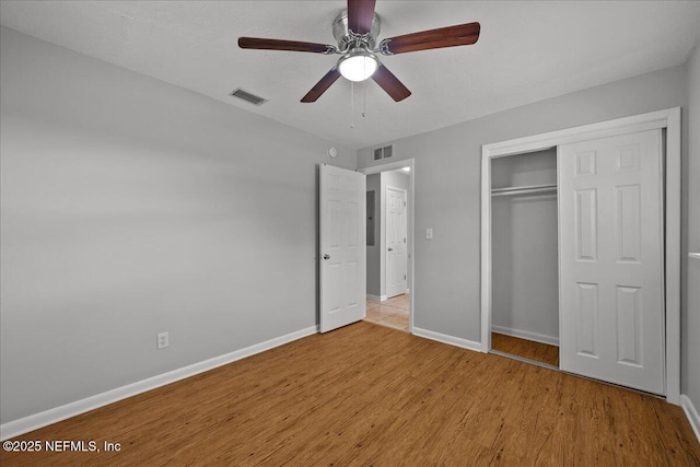 1622 Roselle Ave, Palatka, FL 32177 - unfurnished bedroom featuring wood finished floors, a closet, and a ceiling fan