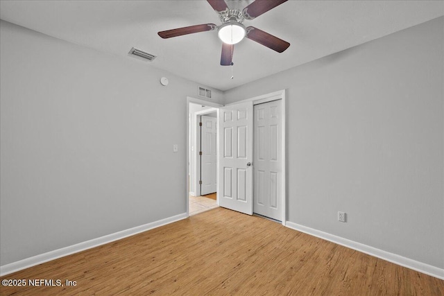 1622 Roselle Ave, Palatka, FL 32177 - unfurnished bedroom with wood finished floors, a closet, and a ceiling fan