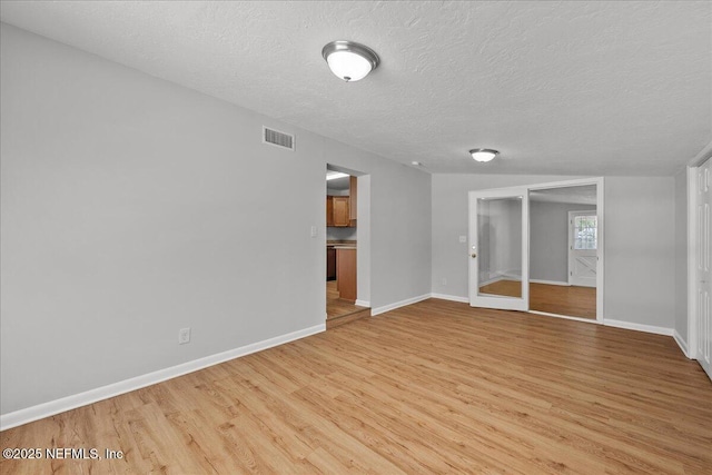 1622 Roselle Ave, Palatka, FL 32177 - empty room featuring light wood-style flooring and a textured ceiling