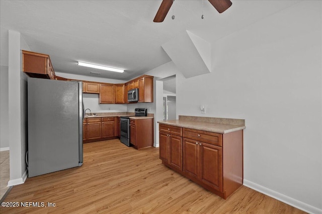 1622 Roselle Ave, Palatka, FL 32177 - kitchen featuring appliances with stainless steel finishes, light wood-type flooring, ceiling fan, brown cabinets, and light countertops