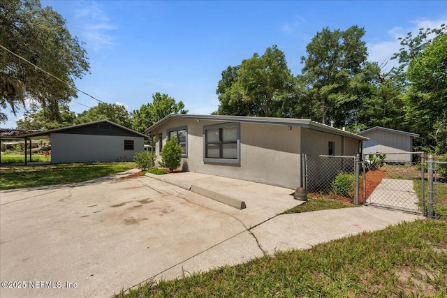 1622 Roselle Ave, Palatka, FL 32177 - view of front of house with stucco siding and a gate