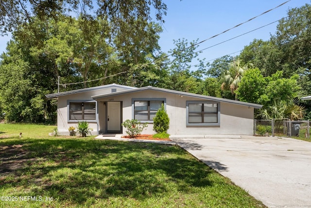 1622 Roselle Ave, Palatka, FL 32177 - view of front of home featuring concrete driveway, stucco siding, and view of wooded area