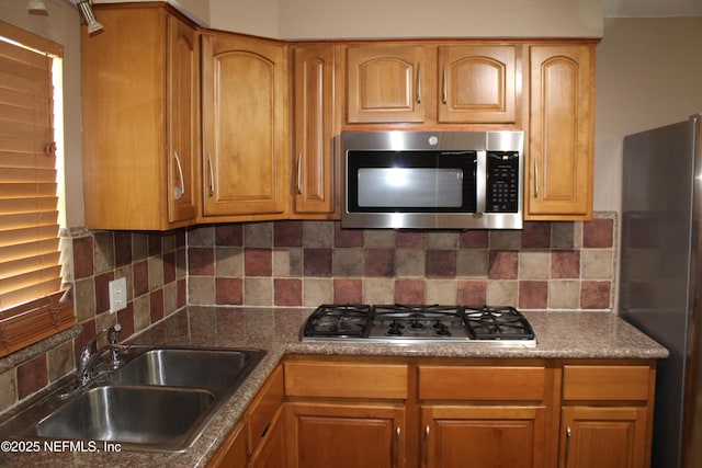 2590 Eastill Dr, Jacksonville, FL 32211 - kitchen featuring stainless steel appliances, decorative backsplash, and brown cabinetry