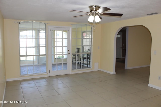 2590 Eastill Dr, Jacksonville, FL 32211 - unfurnished room with arched walkways, a ceiling fan, and tile patterned flooring