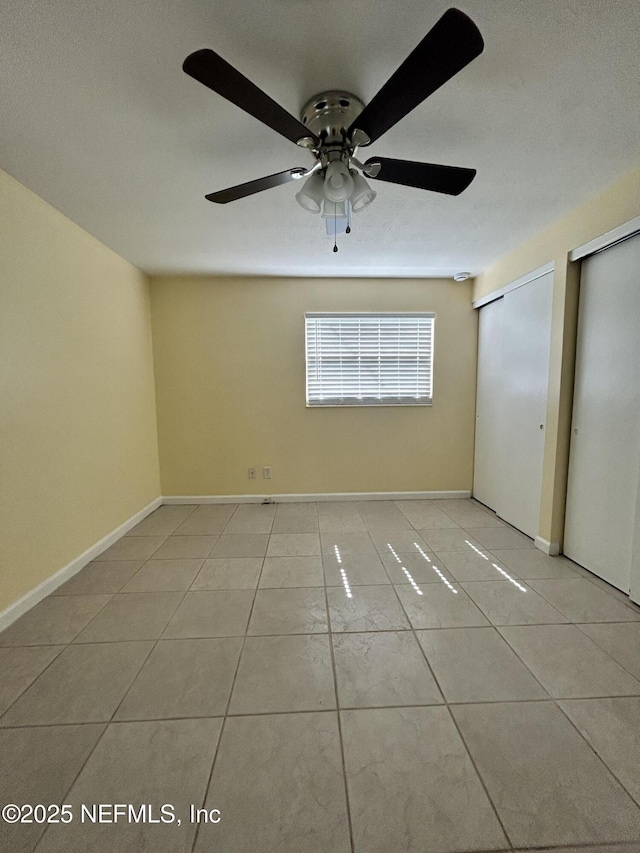 2590 Eastill Dr, Jacksonville, FL 32211 - unfurnished bedroom with light tile patterned floors, multiple closets, and a ceiling fan