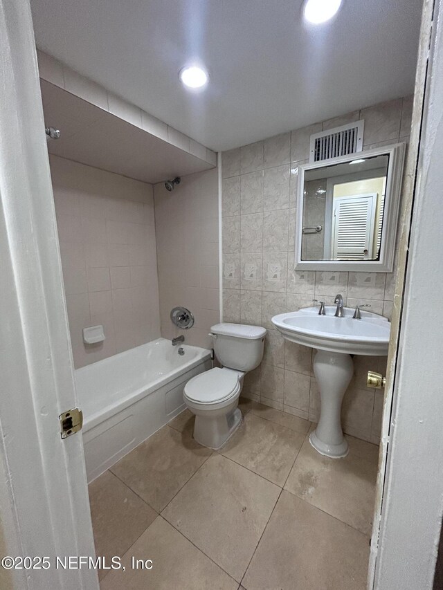 2590 Eastill Dr, Jacksonville, FL 32211 - full bathroom with tile walls, tile patterned flooring, and tub / shower combination
