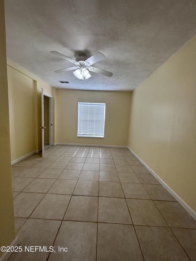 2590 Eastill Dr, Jacksonville, FL 32211 - unfurnished room with light tile patterned floors, a textured ceiling, and a ceiling fan