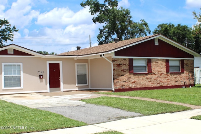 2590 Eastill Dr, Jacksonville, FL 32211 - ranch-style house with a front lawn, brick siding, and roof with shingles