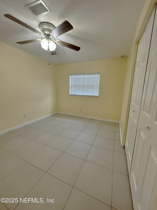 2590 Eastill Dr, Jacksonville, FL 32211 - unfurnished bedroom with a closet, light tile patterned floors, and a ceiling fan