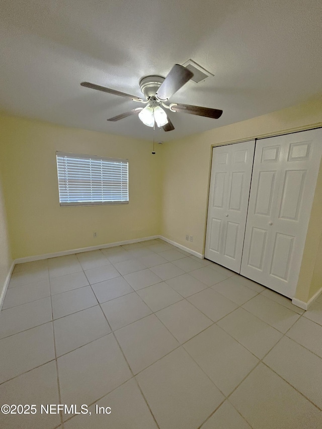 2590 Eastill Dr, Jacksonville, FL 32211 - unfurnished bedroom featuring tile patterned floors, a closet, and ceiling fan