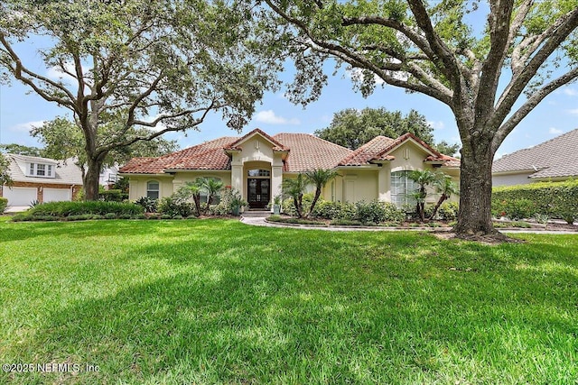 104 Haverhill Dr, Ponte Vedra Beach, FL 32082 - mediterranean / spanish house featuring stucco siding, a tile roof, and a front yard