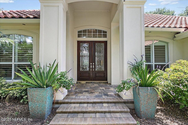 104 Haverhill Dr, Ponte Vedra Beach, FL 32082 - view of exterior entry featuring a tiled roof, stucco siding, and french doors