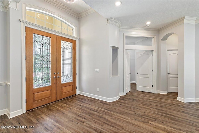 104 Haverhill Dr, Ponte Vedra Beach, FL 32082 - foyer entrance with french doors, dark wood-style flooring, arched walkways, ornamental molding, and recessed lighting