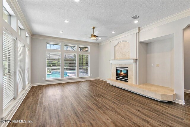 104 Haverhill Dr, Ponte Vedra Beach, FL 32082 - unfurnished living room featuring ceiling fan, ornamental molding, a textured ceiling, wood finished floors, and a tiled fireplace