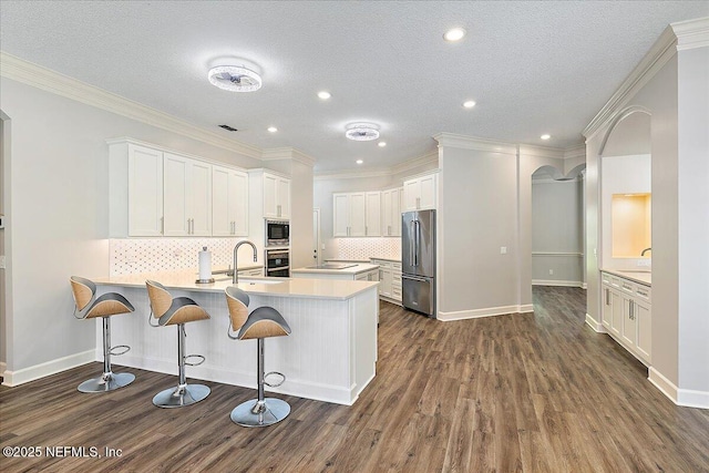 104 Haverhill Dr, Ponte Vedra Beach, FL 32082 - kitchen with stainless steel appliances, a peninsula, dark wood finished floors, backsplash, and recessed lighting