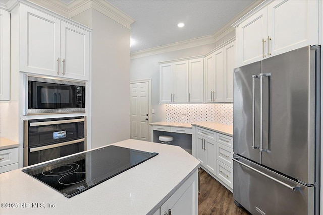 104 Haverhill Dr, Ponte Vedra Beach, FL 32082 - kitchen featuring black appliances, crown molding, white cabinets, light countertops, and recessed lighting