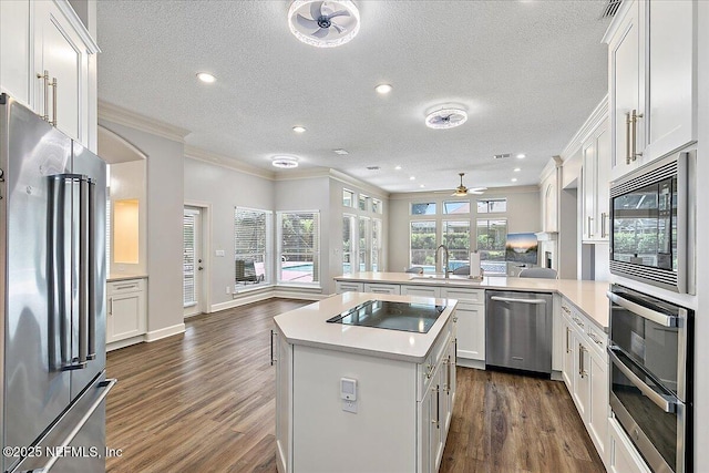 104 Haverhill Dr, Ponte Vedra Beach, FL 32082 - kitchen with black appliances, a peninsula, dark wood-type flooring, ceiling fan, and light countertops