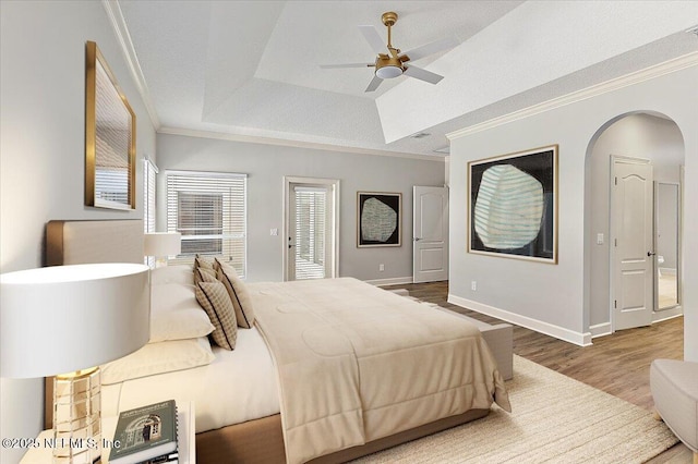 104 Haverhill Dr, Ponte Vedra Beach, FL 32082 - bedroom featuring wood finished floors, a raised ceiling, crown molding, arched walkways, and ceiling fan